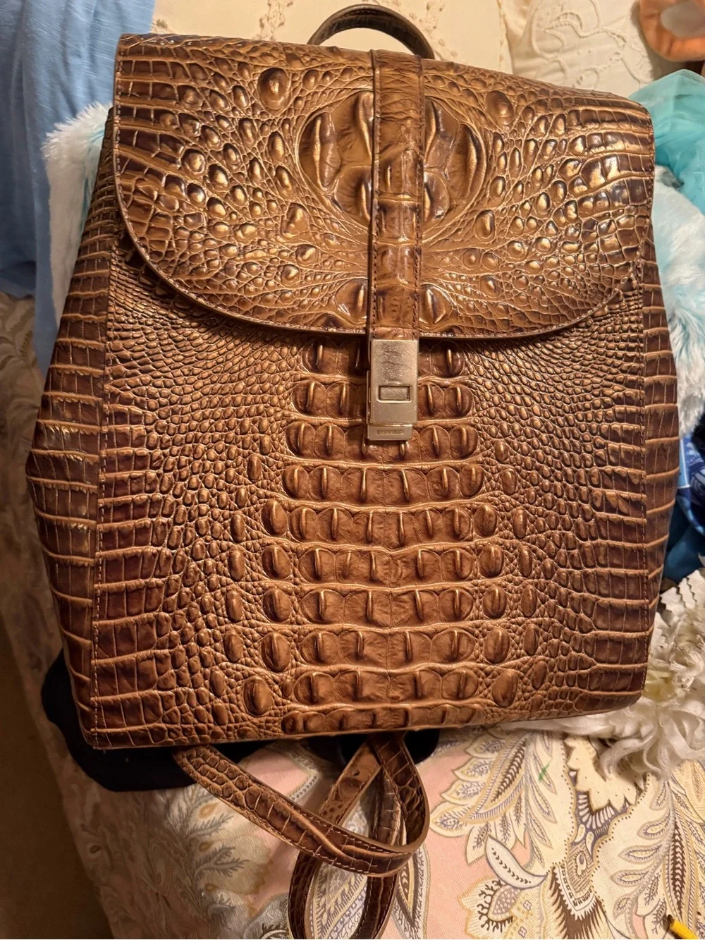 brahmin-rosemary-croc-embossed-leather-backpack Hornback Croco Adele Slim Backpack #HB537 way zip closure Front zip pocket Inside zippered divider and zippered pocket Organizer pockets and pen loops Adjustable shoulder straps Handmade construction Available in Brown Brahmin Brown Croc-Embossed Leather Backpack